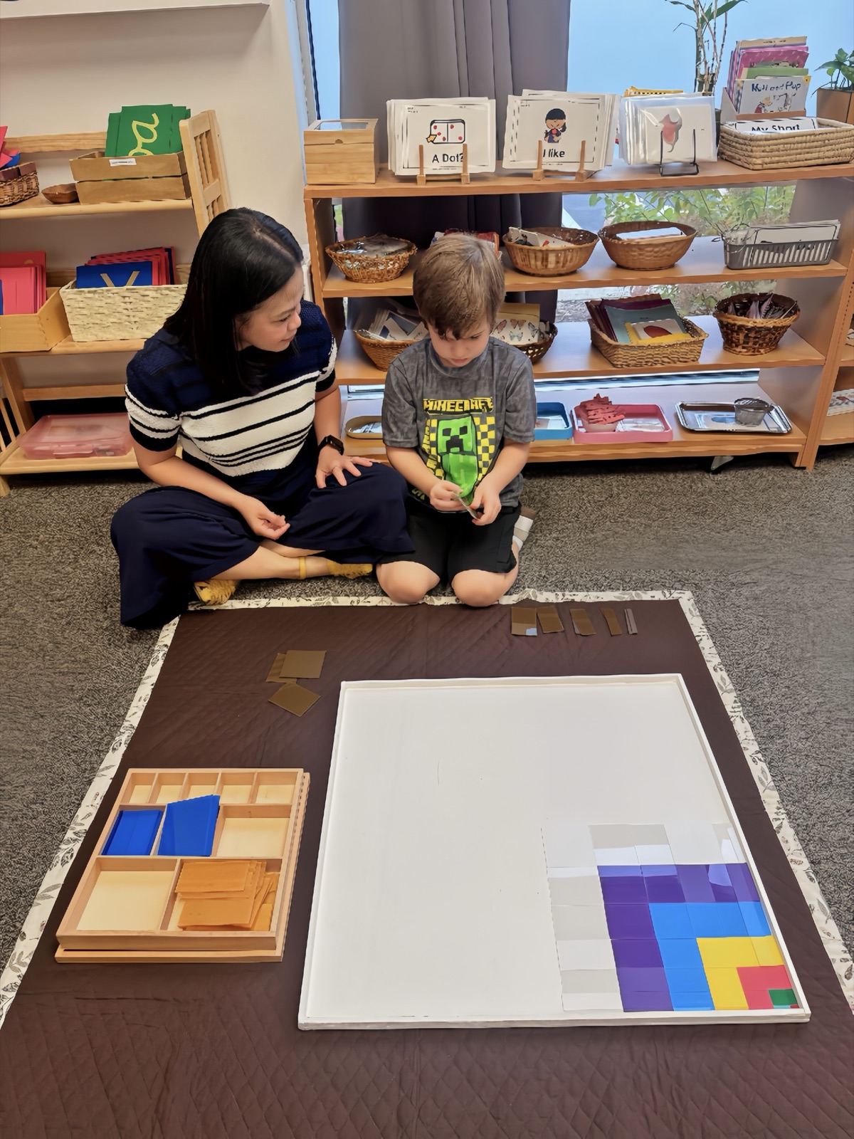 Ms. Marianne with a child at the checkerboard