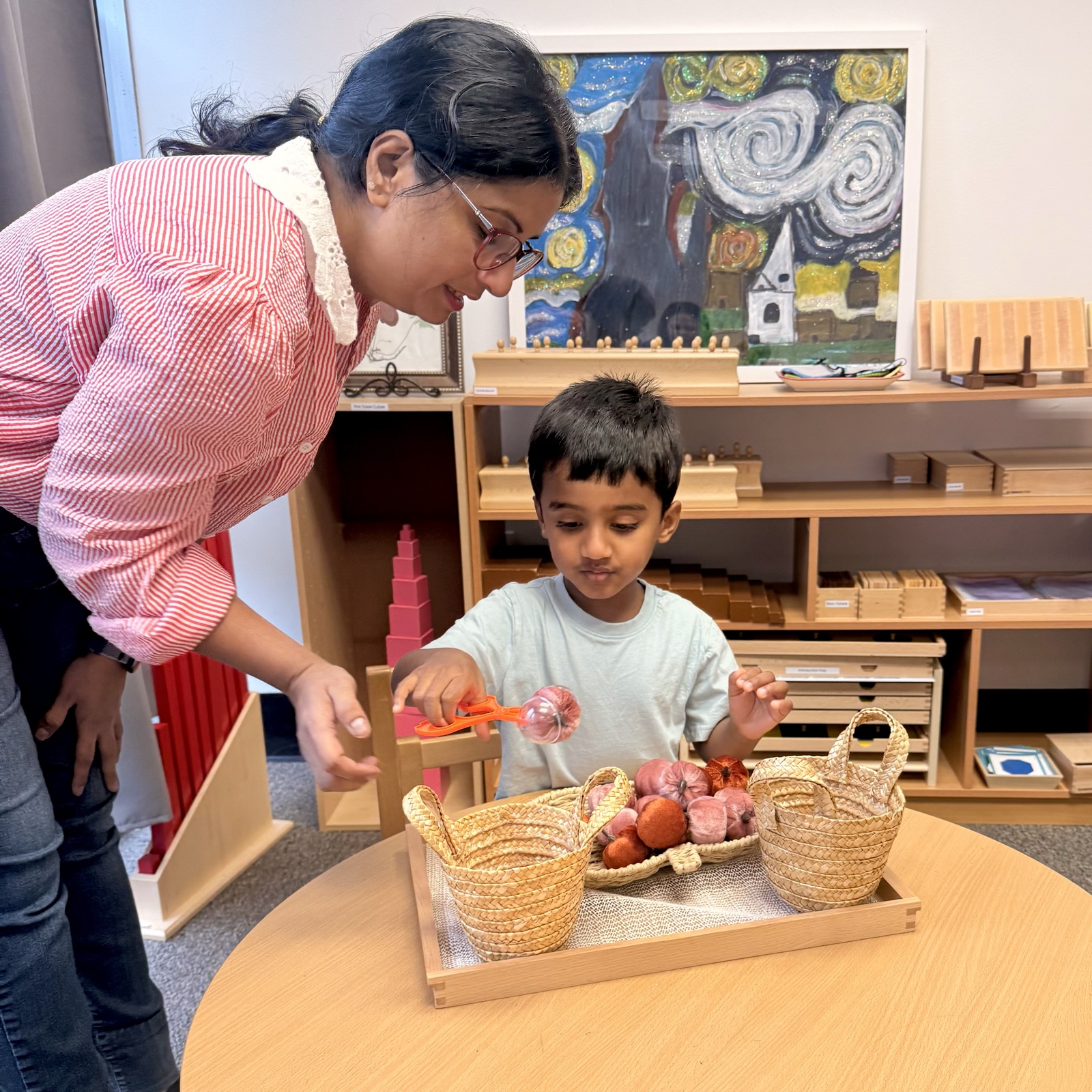 Ms. Payal guiding a child's practical life work